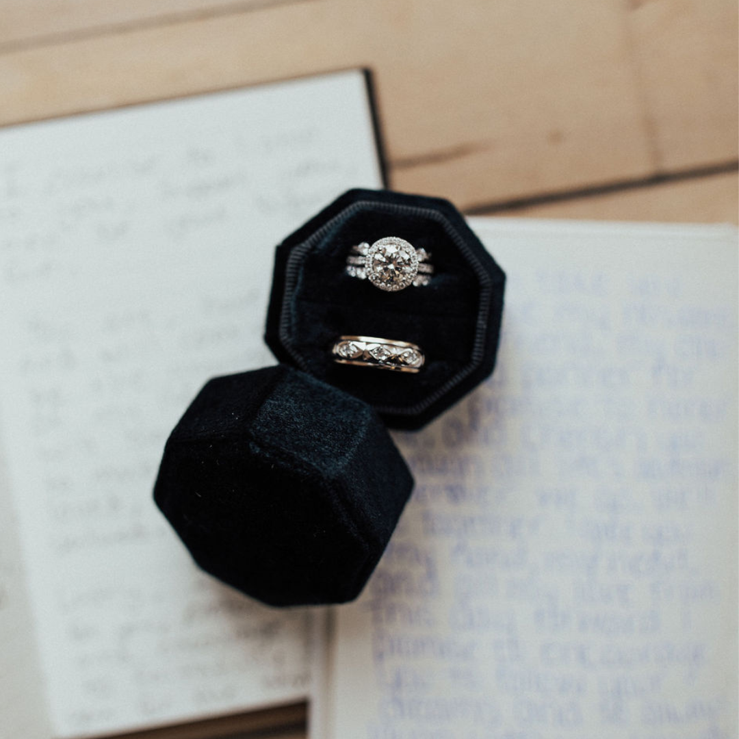 A woman touching her glasses and a fine chain necklace featuring a pearl A woman touching her glasses and a fine chain necklace featuring a pearl