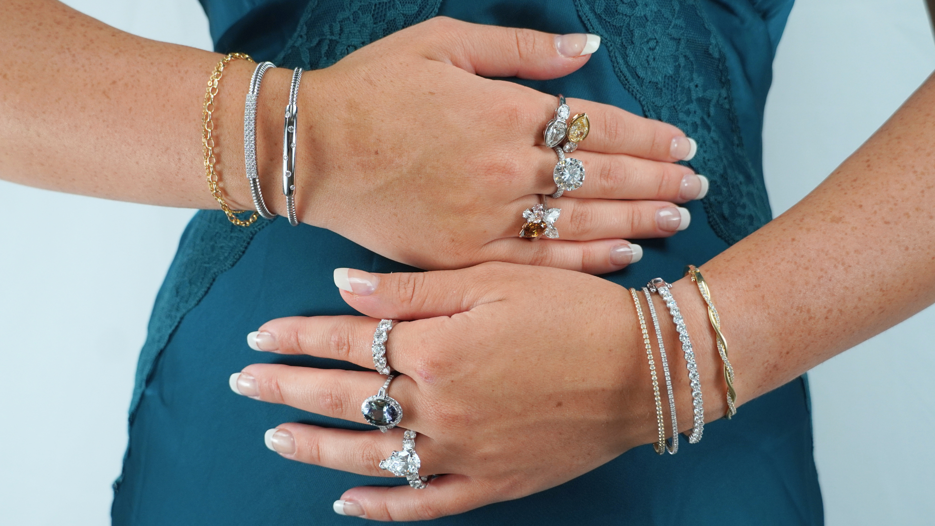 A woman’s hands reaching for a cup of coffee off of a tray, wearing jewelry and a watch A woman’s hands reaching for a cup of coffee off of a tray, wearing jewelry and a watch