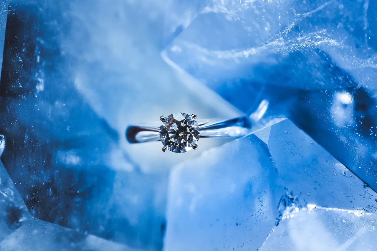 diamond engagement ring on an icy background