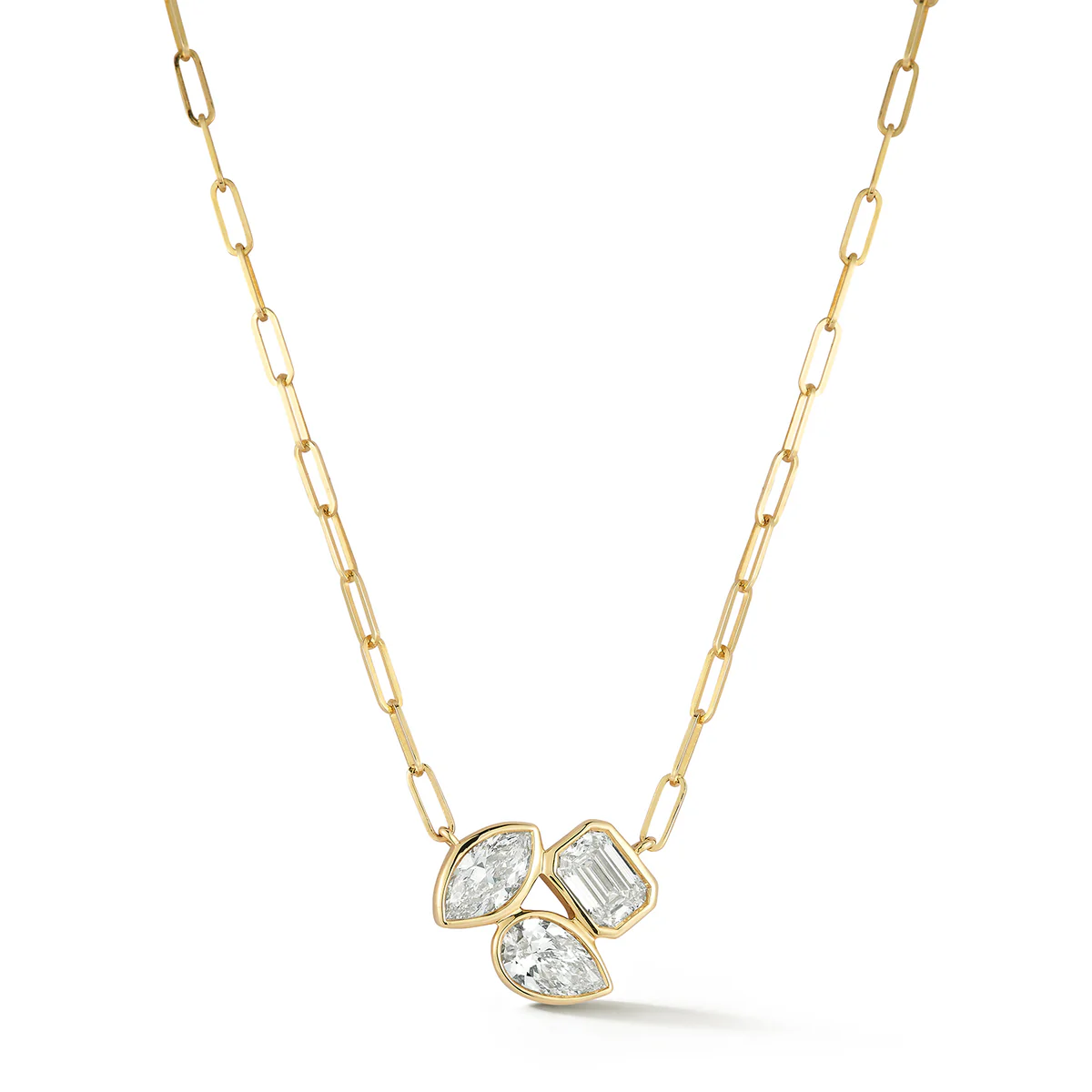 A gold link chain necklace features three unique diamond shapes – marquise, emerald, and pear – clustered at the center.