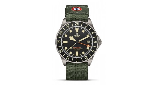 A TUDOR safari-inspired watch with a green fabric strap, available at Exclusively Diamonds.
