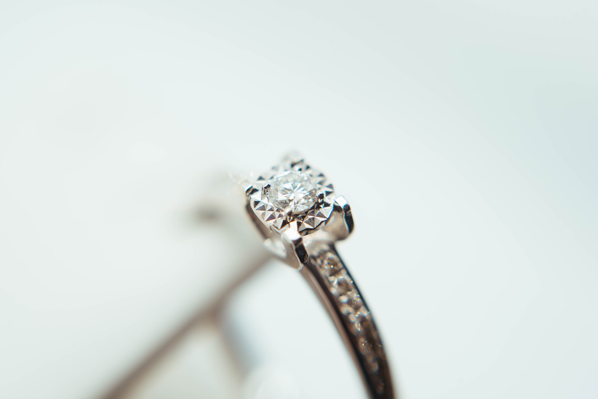 a round cut engagement ring featuring channel set side stones a round cut engagement ring featuring channel set side stones