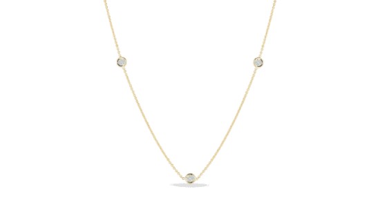 a yellow gold station necklace with round cut diamonds