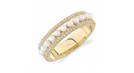 a yellow gold ring with a row of pearls and two rows of diamonds