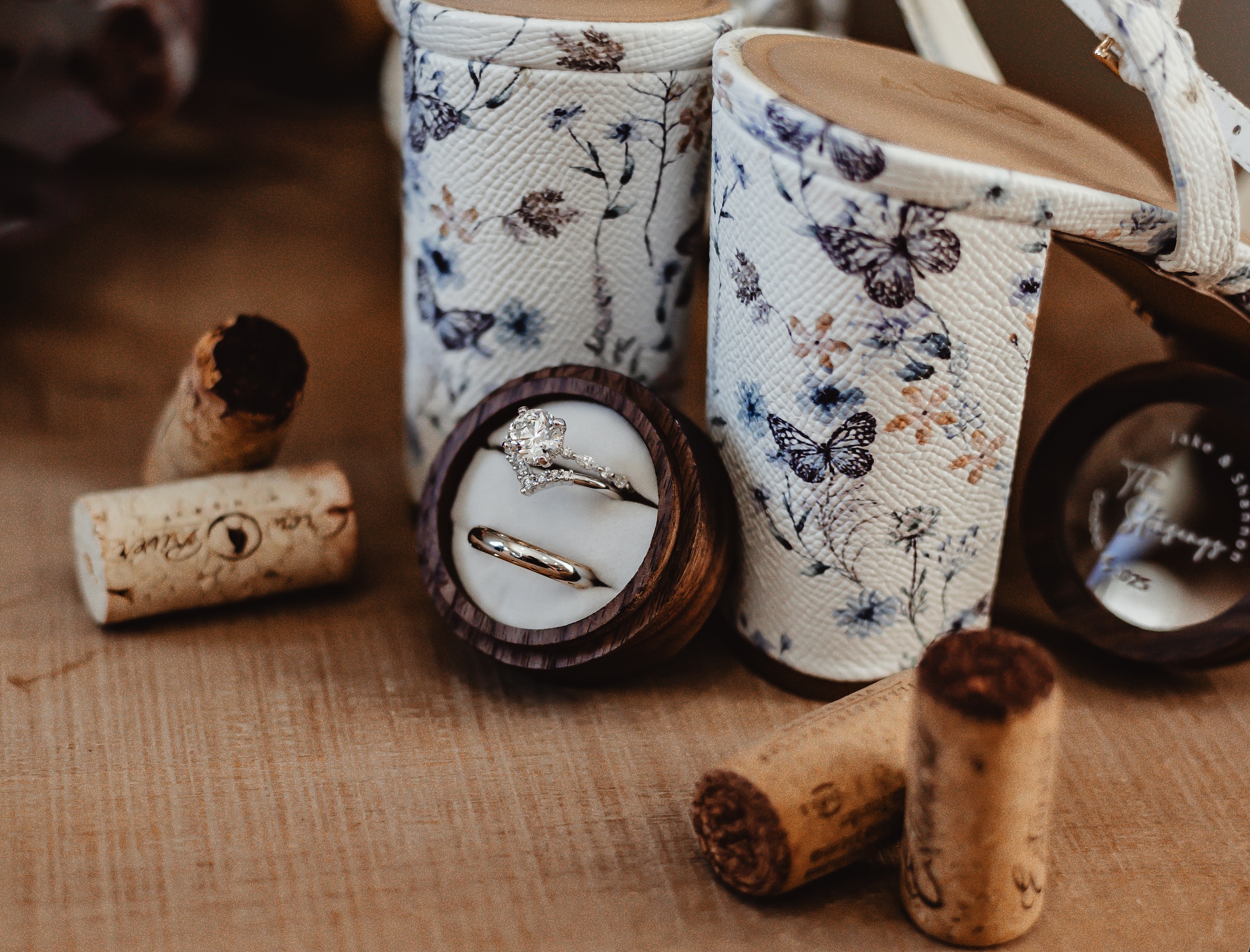 A close-up of a solitaire engagement ring delicately held in a piece of loose weave burlap.