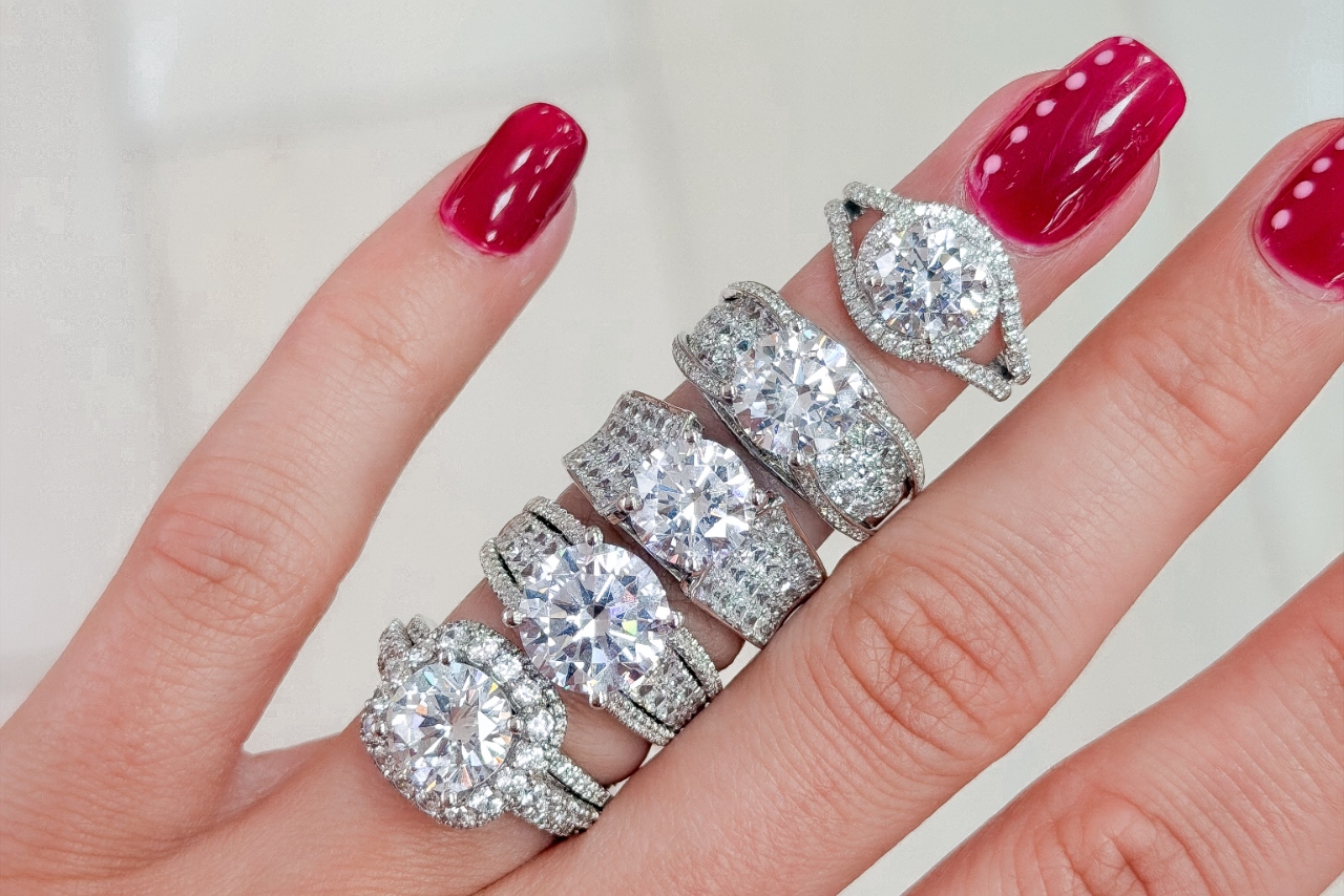 woman's hands wearing many different engagement rings in ring finger woman's hands wearing many different engagement rings in ring finger