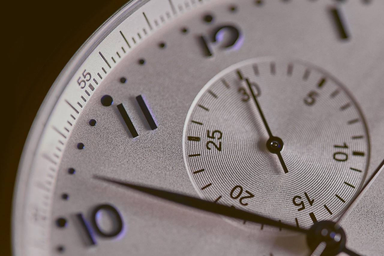 Close shot of a watch dial, showing every detail of the piece