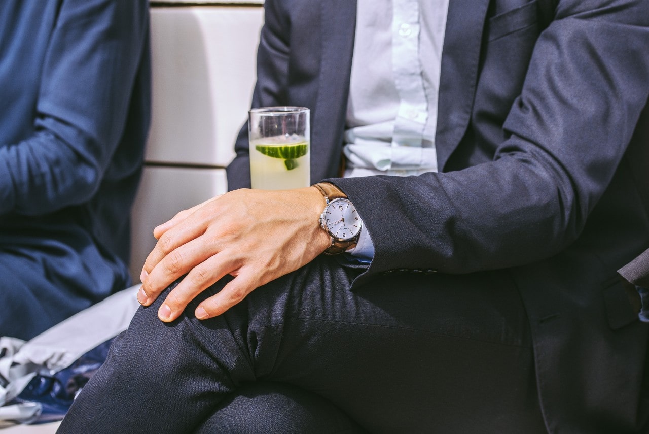 Man in a suit wearing a stately timepiece with a mother-of-pearl dial