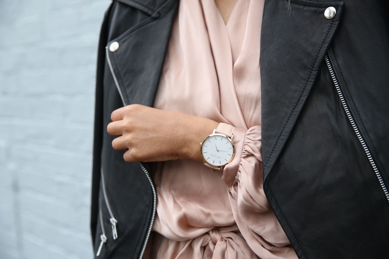 Attractive individual wearing an attractive white and pink wristwatch