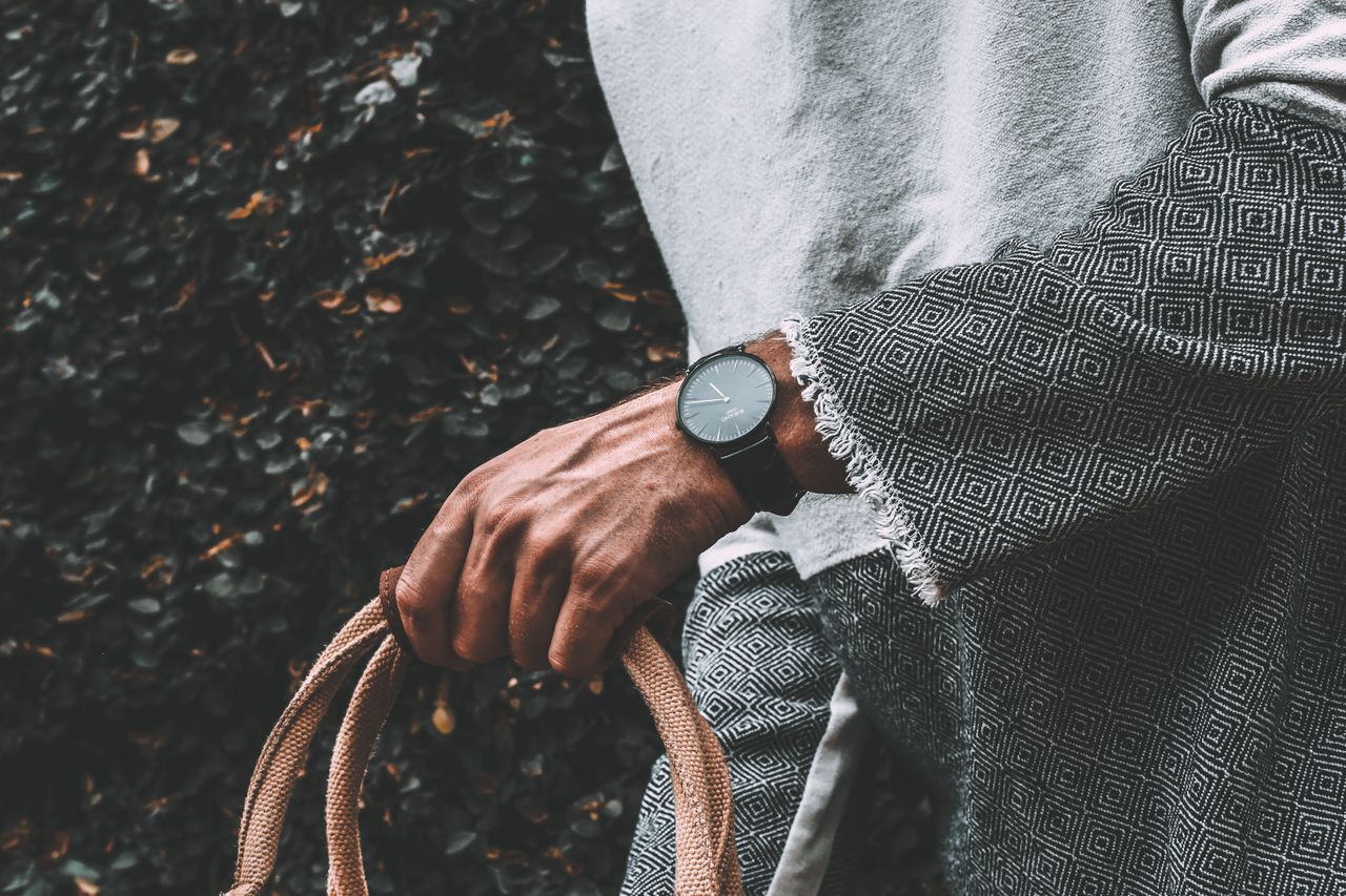 Chic black timepiece donned by a highly fashionable individual