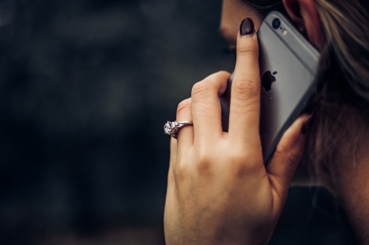 Woman with engagement ring on the phone